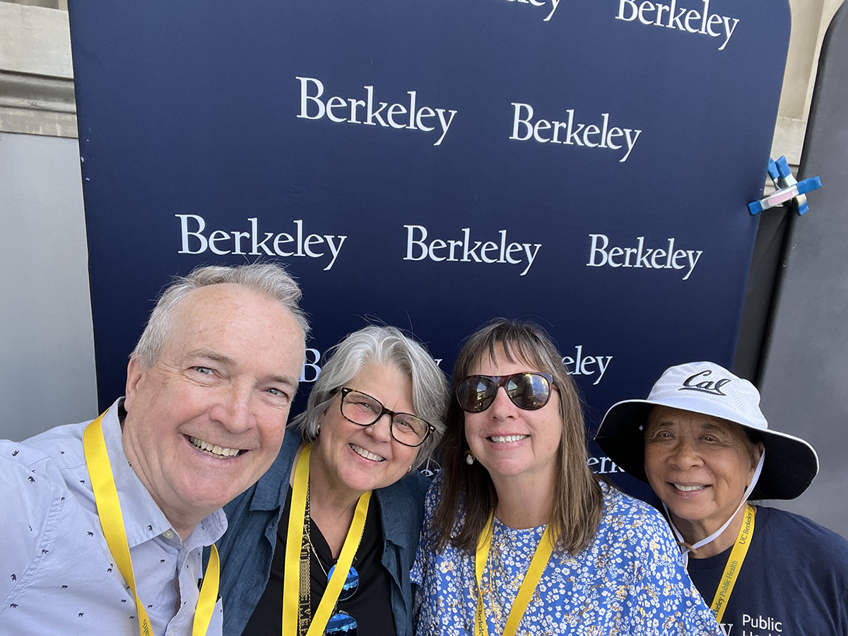 Four PHAA members smile for a photo in front of a Berkeley-branded canvas backdrop.