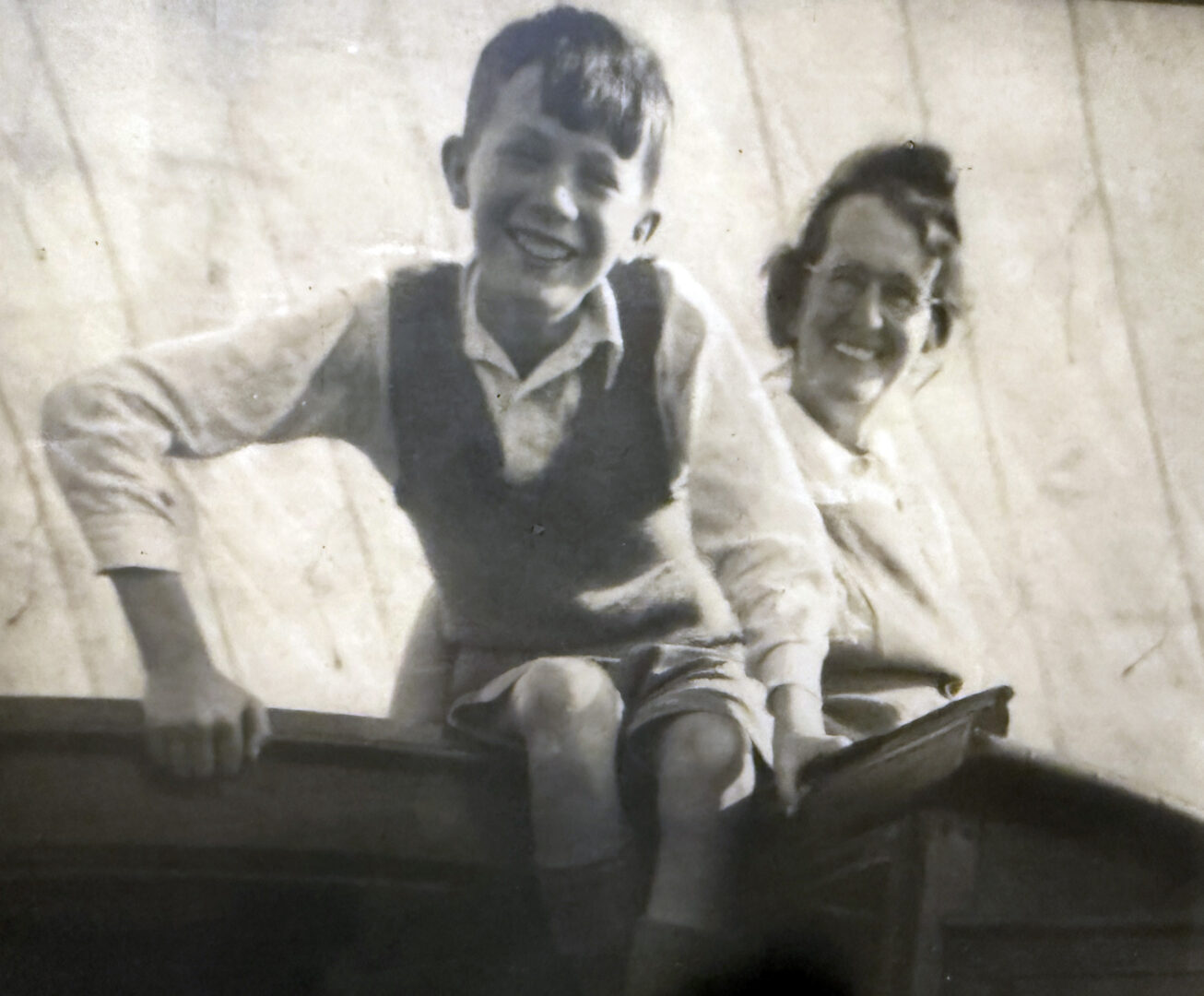 Potts as a young boy poses next to his mother in an aged photograph from the 1940s.