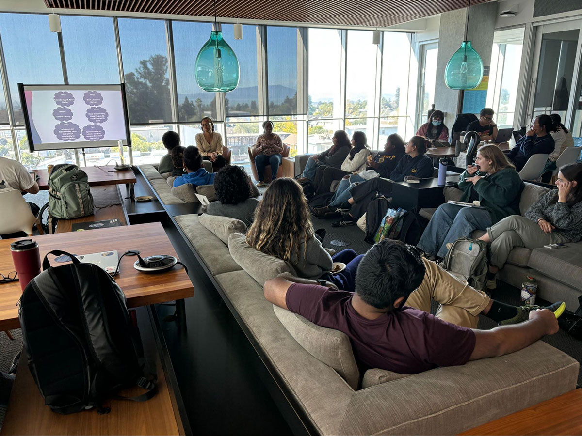 A group of Social Impact Tuesdays participants view a presentation in a conference room.