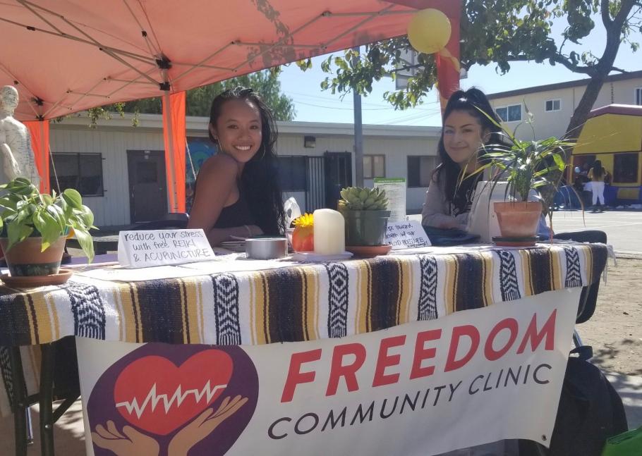Bernadette Lim seated at a Freedom Community Clinic table.