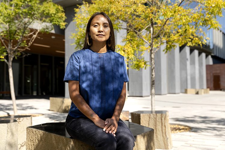 Marlena Robbins, an PhD student at the UC Berkeley School of Public Health, sits for a portrait outside of the School of Public Health in Berkeley, Calif. on Thursday, Aug. 18, 2022.